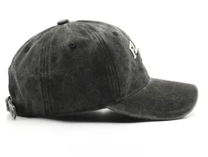 Detailed side view of washed vintage cotton baseball cap with white 3D letter embroidery