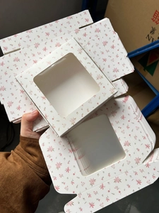 Detail of pink floral gift box with square window and sturdy white cardboard base