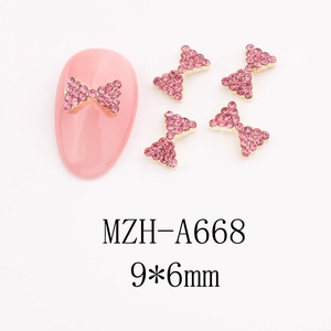 Detail of pink rhinestone bow nail charms with gold alloy base, size 9x6mm, model MZH-A668