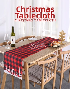 Close-up of red and black buffalo plaid Christmas table runner with white reindeer print