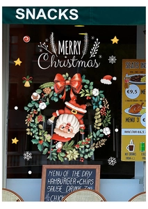 Detailed view of Merry Christmas window stickers with Santa Claus and festive wreaths