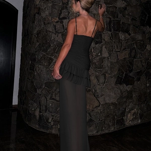 Elegant black strapless evening dress with ruffled mesh hem and open back detail