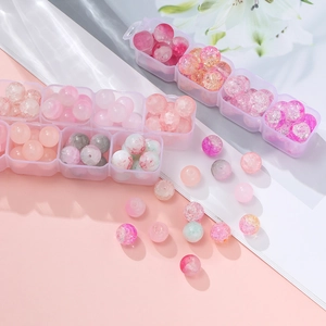 Pink and white glass beads for DIY jewelry making in a transparent storage container