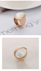 Macro detail of rose gold ring featuring an oval mother of pearl inlay and brushed texture