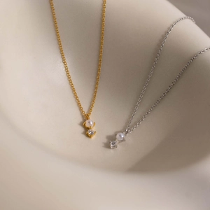 Titanium steel birthstone necklaces with pearl and zircon charms in gold and silver finish