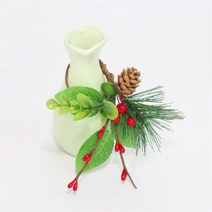 Close-up of ceramic vase with festive red berries, pine cones and needles for table decor