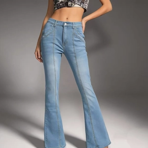 Detail showing the slim fit high-waisted light blue flared denim jeans on model