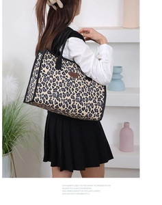 Detailed back view of a stylish leopard print canvas tote bag carried over the shoulder