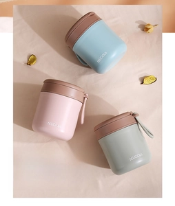 Close-up of three colorful 304 stainless steel soup mugs with handles and lids