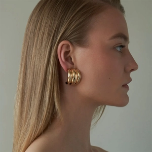 Polished 18k gold plated multi-layer C-hoop earrings on model for a stylish look