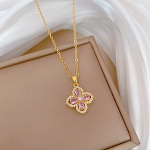 Macro shot of pink clover pendant with zircons on a luxury leather jewelry box