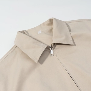 Short beige jacket with classic lapel collar and silver metal zipper detail for women