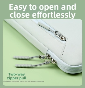 Detail of smooth two-way metal zippers on protective green laptop sleeve case
