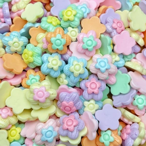 Macro shot of colorful resin flower beads in mixed pastel colors for jewelry making
