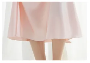 Detail of ruffled hemline with lettuce edge finish on a soft pink V-neck nightgown