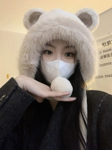 Close-up of white plush bear ear hat with soft texture and thickened warm fleece lining