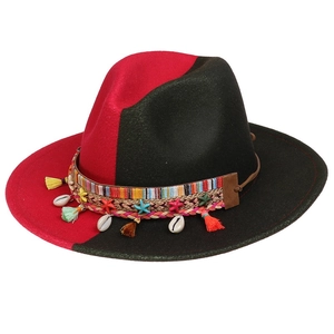 Detail of red and black felt fedora featuring ethnic band with shells and tassels
