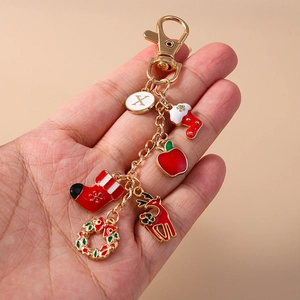 Christmas keychain with gold chain featuring Santa socks, reindeer, and letter X charms
