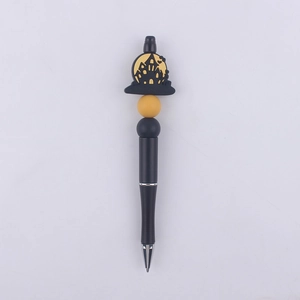 Detail of DIY beaded pen featuring a haunted castle silicone bead for Halloween décor