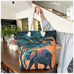 Detailed texture of jacquard elephant tote bag with colorful geometric woven pattern