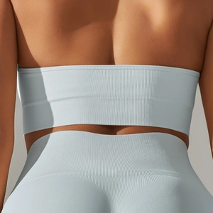 Macro view of seamless light blue ribbed knit fabric on a sports bra and leggings set