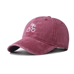 Vintage washed burgundy cotton baseball cap featuring white cherry embroidery from 45-degree angle