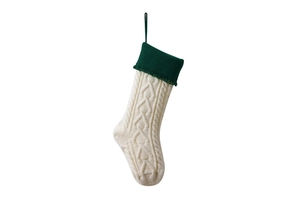Detail of cable knit Christmas stocking in cream and dark green with a hanging loop