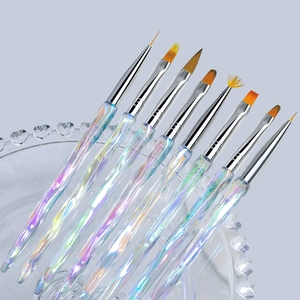Detailed view of 8 professional nail art brushes with iridescent handles on a glass tray