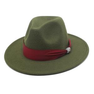 Detailed texture of dark green wool felt fedora with burgundy ribbon and crystal buckle