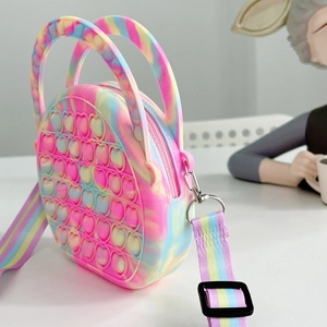 Close-up of heart-shaped pop-it bubbles on tie-dye silicone crossbody bag for kids