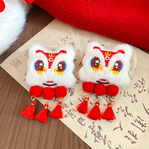 Close-up of traditional Chinese dancing lion hair clip with white fur and red tassels