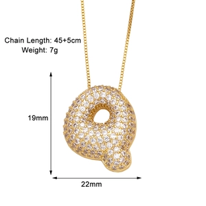 Detail view of gold letter Q necklace with cubic zirconia and dimensions 19mm by 22mm