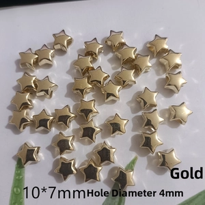 Close-up of 10x7mm gold star beads with 4mm aperture for DIY jewelry making
