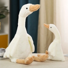 Detail of two white duck plush toys in different sizes with soft textured fabric