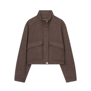 Detailed close-up of dark brown wool jacket featuring gold buttons and large pockets