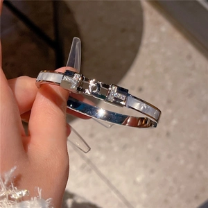 Silver stainless steel T-shape bracelet with white inlay and sparkling crystal H-buckle
