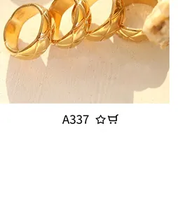 Detailed view of four chunky gold rings featuring distinct quilted pattern engraving