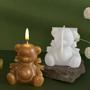 Detail of 3D bear candle silicone mold with bow-knot and finished resin craft