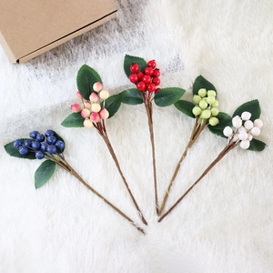 Artificial colorful berry branches with green leaves for home floral decoration