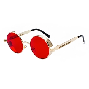 Retro steampunk sunglasses with golden round metal frames and vibrant red circular lenses