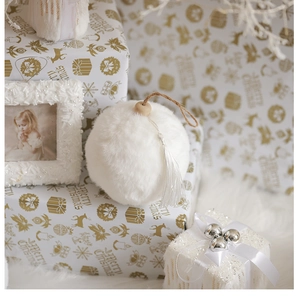 Detail of white plush Christmas ball with wooden bead, jute loop and elegant tassel
