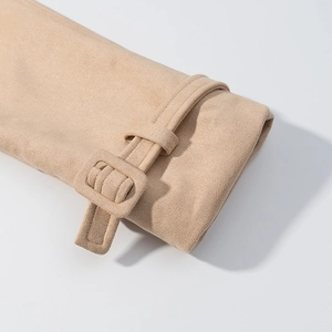 Detailed close-up of beige faux suede sleeve cuff with fabric-covered square buckle