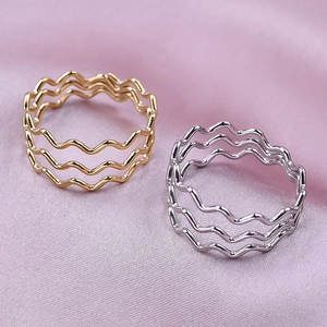 Detailed view of layered wavy 304 stainless steel rings in gold and silver plating