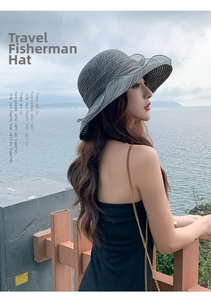 Outdoor model shot of dark grey wide brim sun hat with wavy edges and breathable fabric