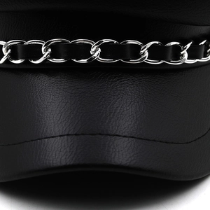 Detailed close-up of leather baker boy hat with silver chain and braided leather strap