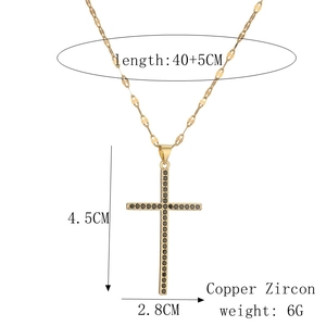 Detailed view of golden cross pendant with black zircon stones and dimension markings
