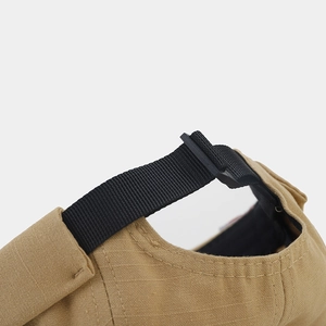 Detail of adjustable black nylon strap and khaki ripstop fabric on a docker cap