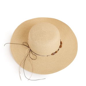 Detailed texture of hand-woven straw hat with wooden beads and elegant bow tie