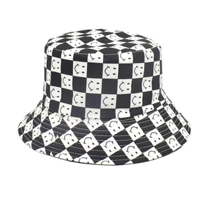 Close-up of black and white checkerboard bucket hat with embroidered smiley patterns