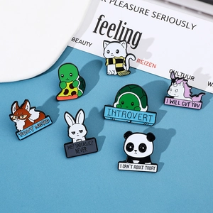 Detailed view of colorful enamel animal pins with funny quotes on a blue background
